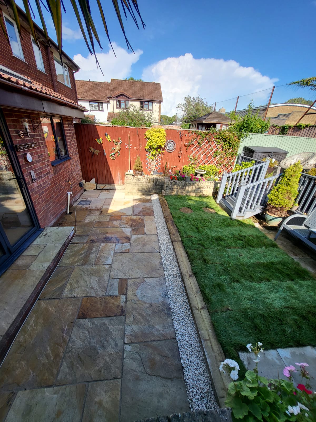 Patio paving with lawn and decorative gravel border