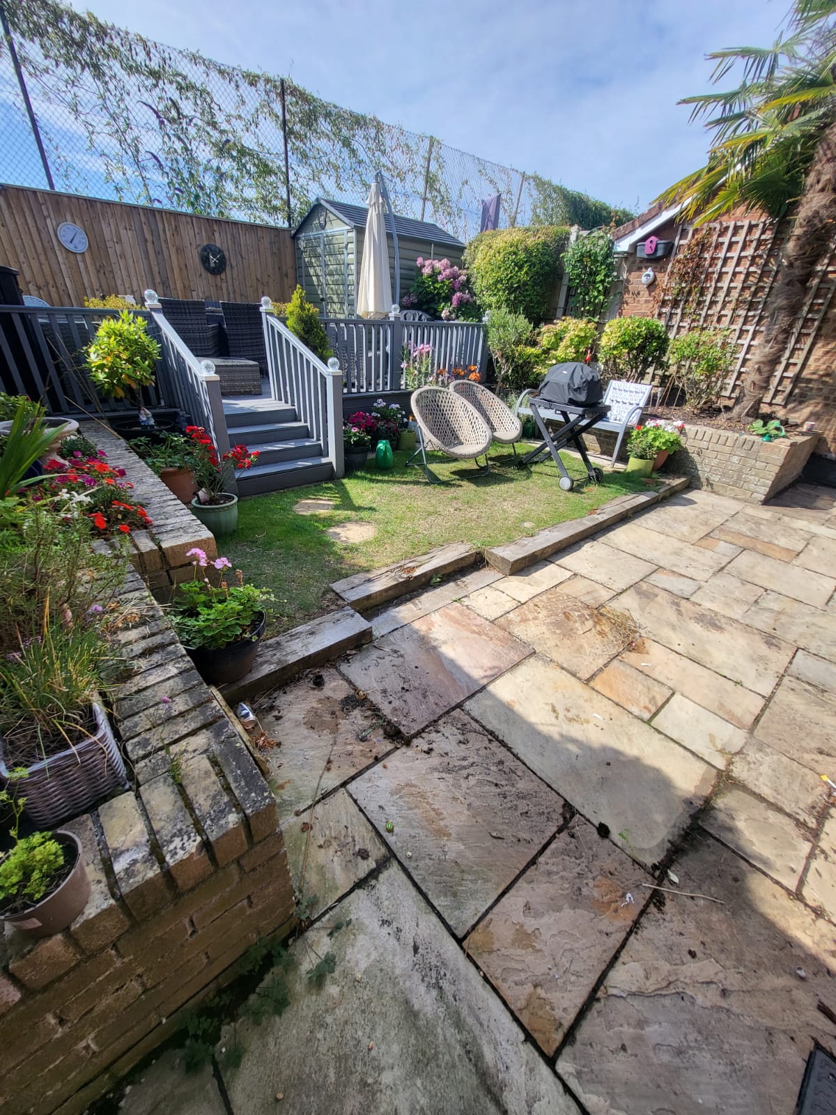 Garden patio with lawn, planting and seating area