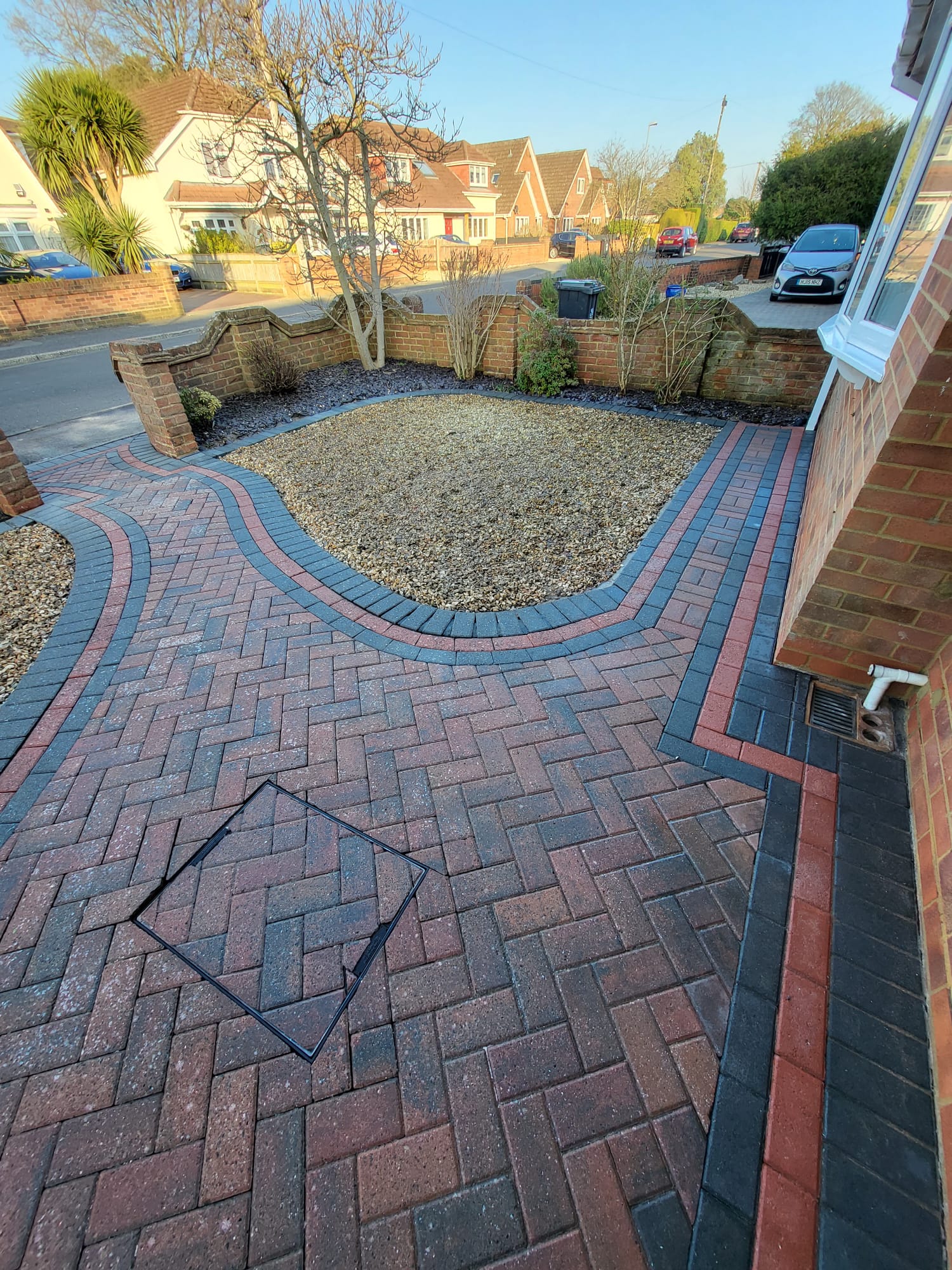 Block paved driveway and gravel front garden
