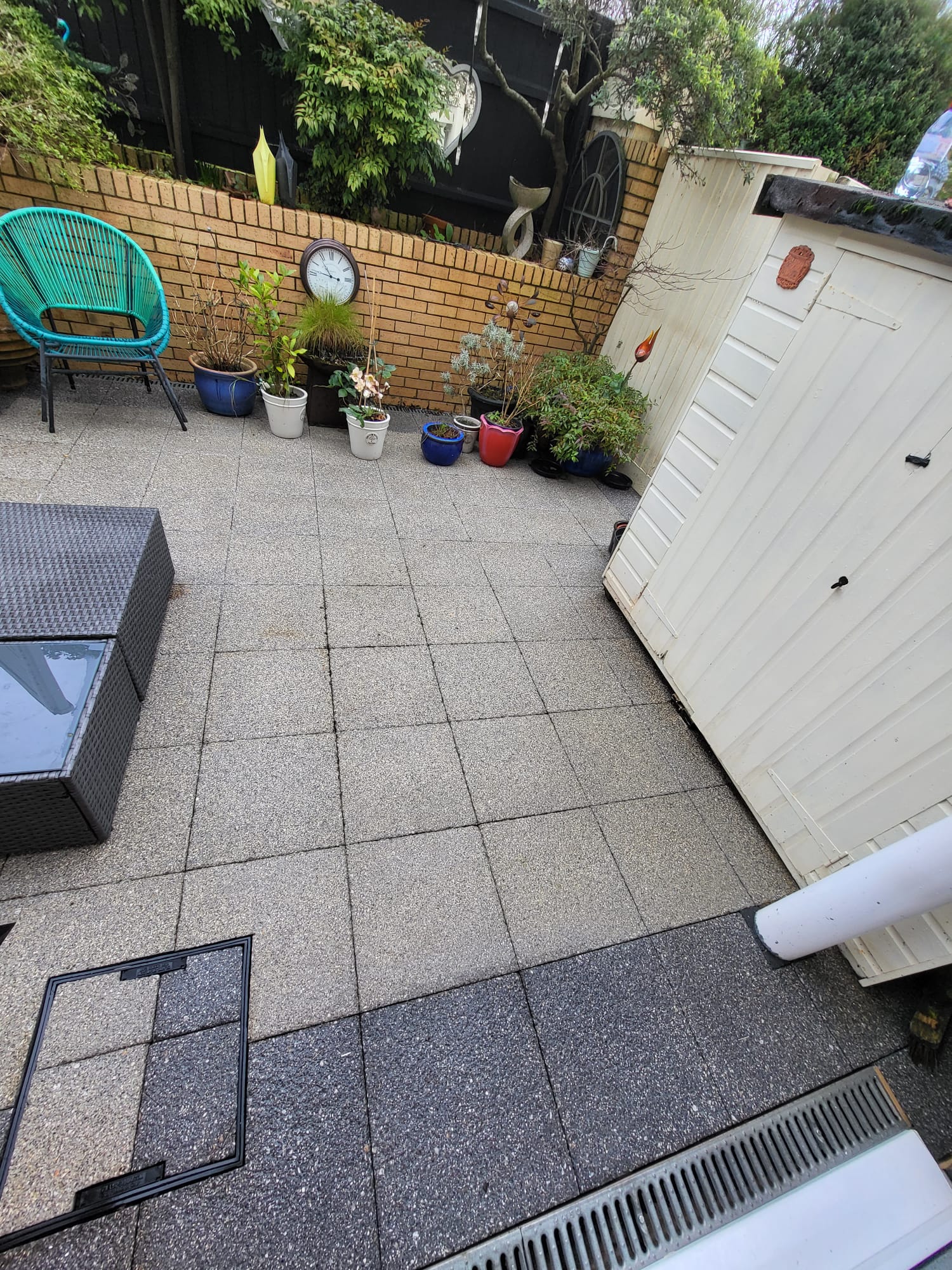 Garden seating area with potted plants and paving